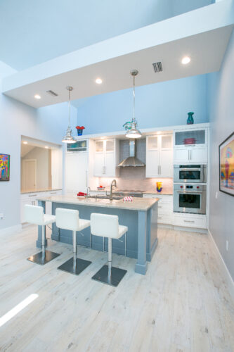 This is a picture of a bright and open kitchen in Nokomis, Florida with custom made cabinetry by Kountry Kraft Cabinetry. 