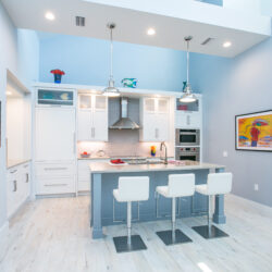 This is a picture of a bright and white kitchen with custom made cabinets by Kountry Kraft Cabinetry.