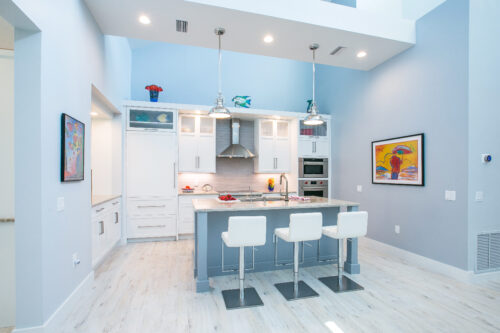 This is a picture of a bright and white kitchen with custom made cabinets by Kountry Kraft Cabinetry. 