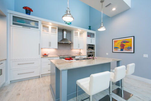 This is a picture of a custom-made kitchen island with an extra leg by Kountry Kraft Custom Cabinetry.