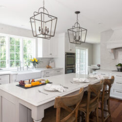 This is a picture of a white kitchen and honey brown wood flooring with custom cabinets from Kountry Kraft Cabinetry.