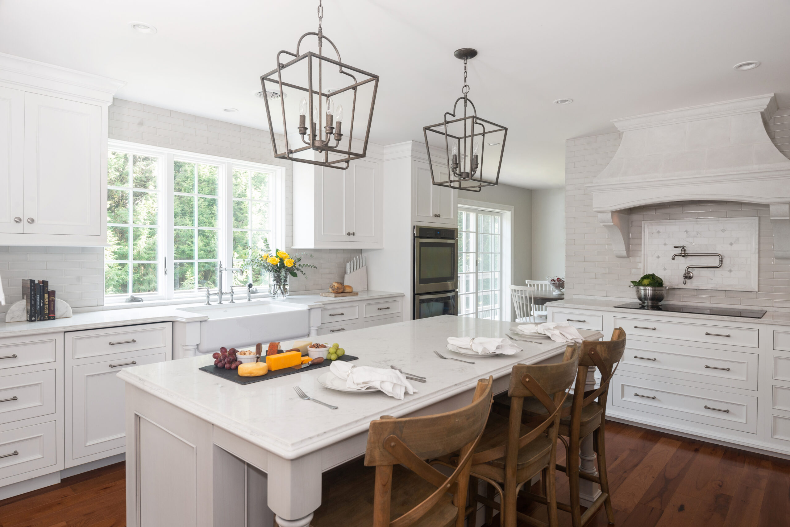 This is a picture of a white kitchen and honey brown wood flooring with custom cabinets from Kountry Kraft Cabinetry.