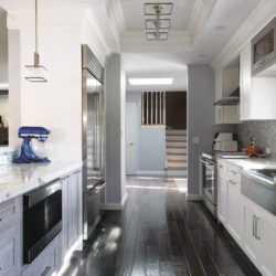 This is a picture of a silver kitchen with white cabinetry custom made by Kountry Kraft Cabinetry.