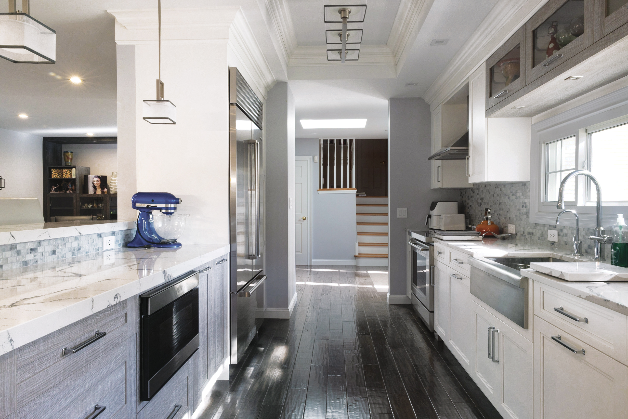 This is a picture of a silver kitchen with white cabinetry custom made by Kountry Kraft Cabinetry.