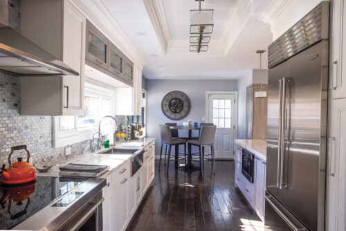 This is a picture of a silver kitchen in Great Neck New York with custom cabinetry by Kountry Kraft Cabinetry. 