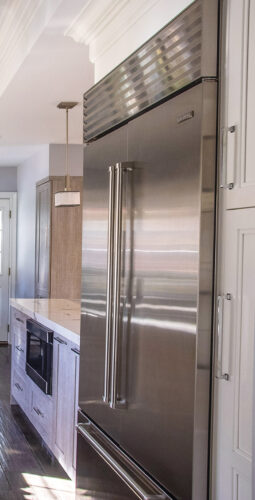 This is a picture of a silver kitchen in Great Neck New York with custom cabinetry by Kountry Kraft Cabinetry.