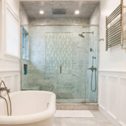 This is a picture of a white bathroom in Point Lookout New York with custom made cabinets by Kountry Kraft Cabinetry.