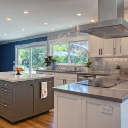 This is a picture of a blue and white kitchen with a custom floating island and cabinetry from Kountry Kraft Cabinetry.