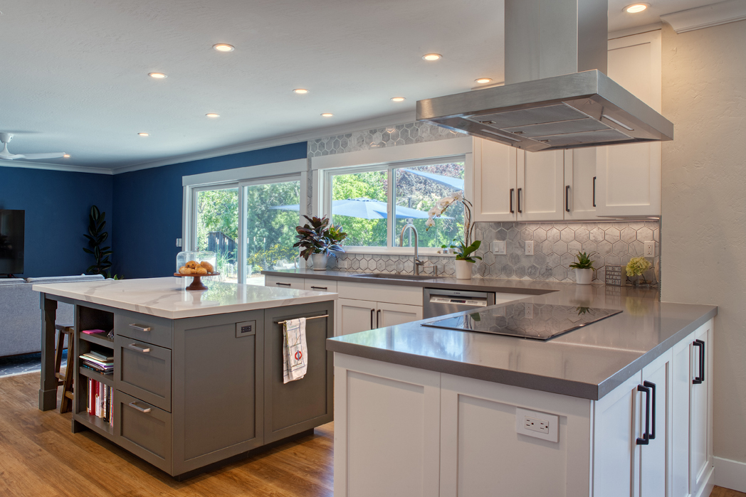 This is a picture of a blue and white kitchen with a custom floating island and cabinetry from Kountry Kraft Cabinetry.