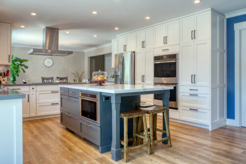 This is a picture of a white kitchen with blue splashes in California with custom cabinets by Kountry Kraft Cabinetry.