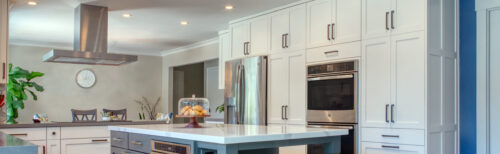 This is a picture of the mix of white and blue colors from a kitchen in California with custom cabinets by Kountry Kraft Cabinetry. 