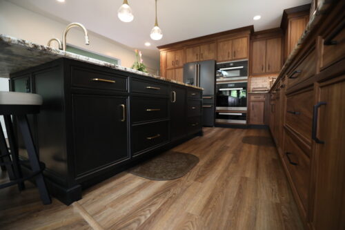 This is a picture of dark black cabinetry included custom made knobs from Top Knobs Designs.