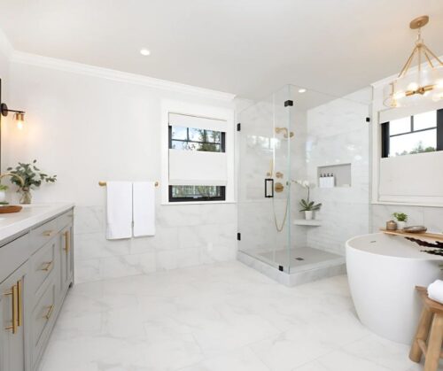 Bathrrom remodel in Lafayette California with Gray cabinets gold hardware marble floors and a valet in the hallway prior