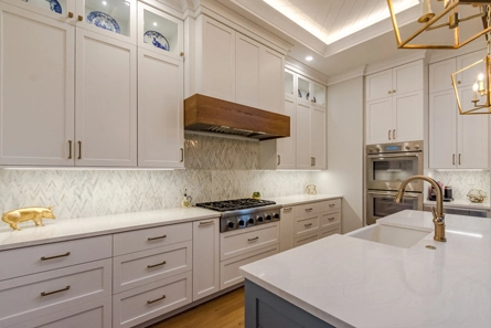 Gray and White Kitchen Cabinets with Brass Hardware and Wood Accents in South Carolina