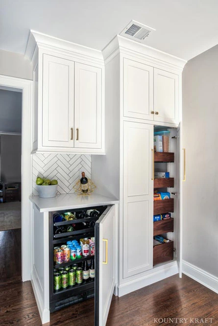 Custom Alpine White Kitchen Cabinetry Camouflages Beverage Fridge and Pantry