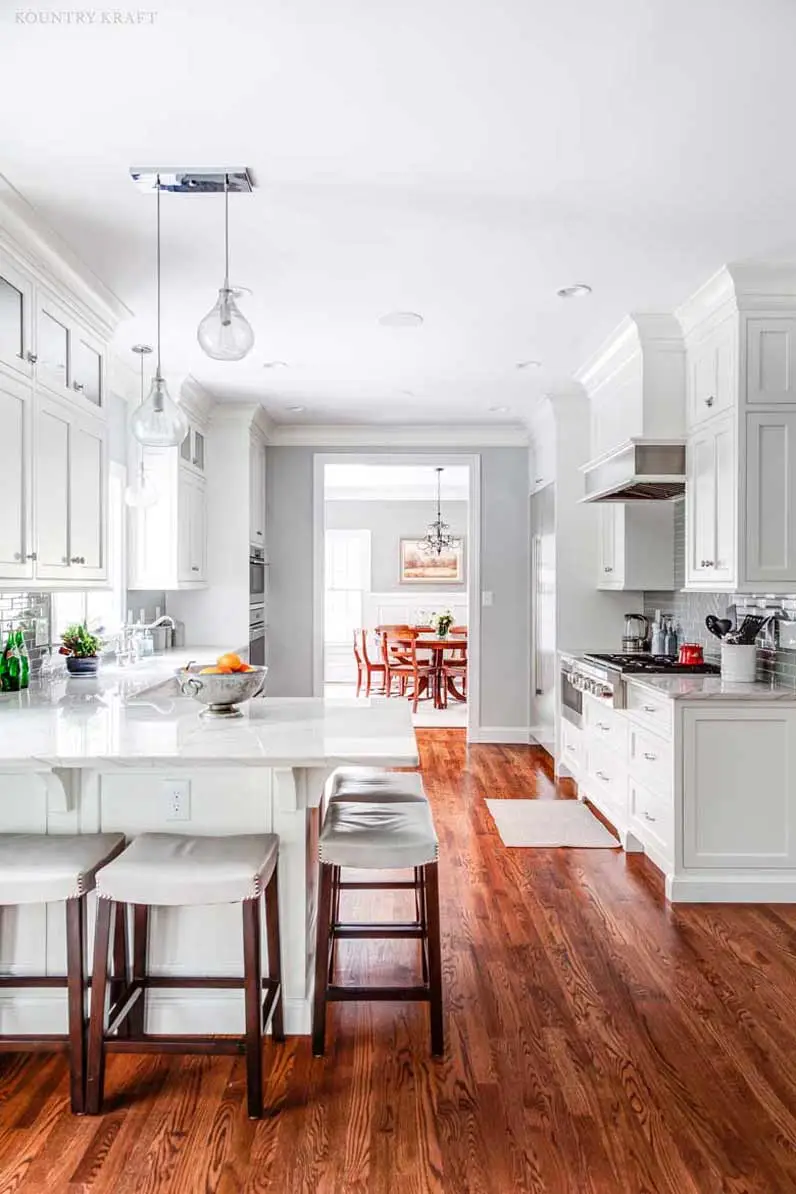 Five stools under an L-shaped counter and hard maple cabinets Madison, New Jersey