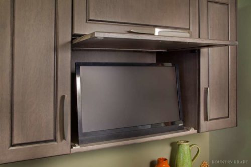 Hidden TV Cabinet and Other Custom Storage Options Are Used in this traditional Kitchen Design