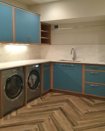 this custom laundry room features custom closets and cabinetry