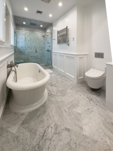 This is a picture showcasing the unique herringbone floor for a bathroom in Point Lookout New York.