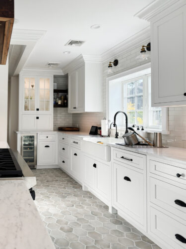 This is a picture of a narrow white kitchen with custom cabinetry by Kountry Kraft Cabinetry.