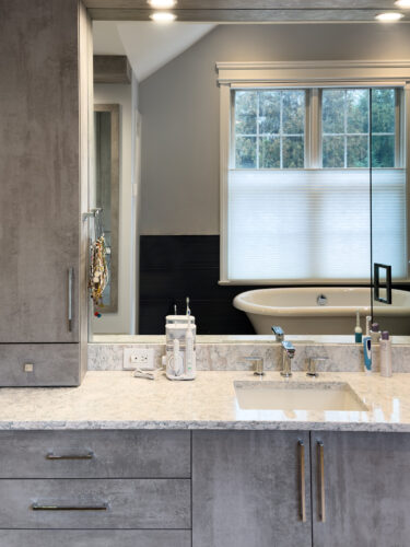 This is a picture of the drawers and bureau of a bathroom in Nesconset NY with cabinets by Kountry Kraft Cabinetry. 