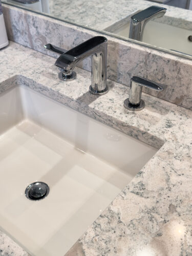 This is a picture of the Hansgrohe faucet and Kohler sink with custom cabinets by Kountry Kraft Cabinetry. 