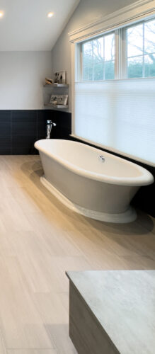 This is a picture of a sleek white standalone bath in a bathroom in Nesconset New York. 