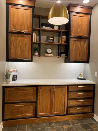 This is a picture of a dark, walnut stained office desk from Inde Studios with custom-made cabinetry by Kountry Kraft Cabinetry. 