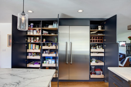 A Current Kitchen Cabinet Trend is Incorporating a Storage Wall into a Kitchen