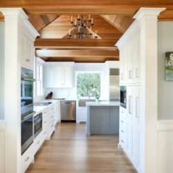 Kitchen remodel in clinton Ct with white cabinets and a wood ceiling