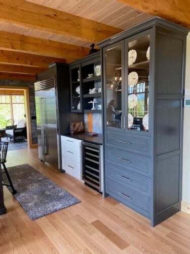 blue kitchen cabinets with a wine fridge