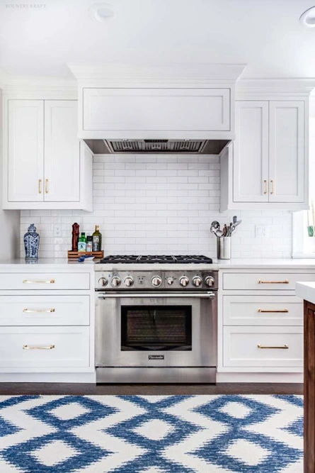 Kitchen with subway tile, stainless steel range and white cabinets Summit, NJ