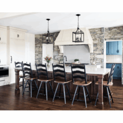 This Lebanon, PA kitchen remodel transforms a home with Kountry Kraft’s Penn Line custom cabinetry, finished in Benjamin Moore Hush AF-95. The kitchen blends classic design with modern functionality, featuring a large custom range hood over a Wolf double range, a vibrant blue butler’s pantry, and a spacious island seating six