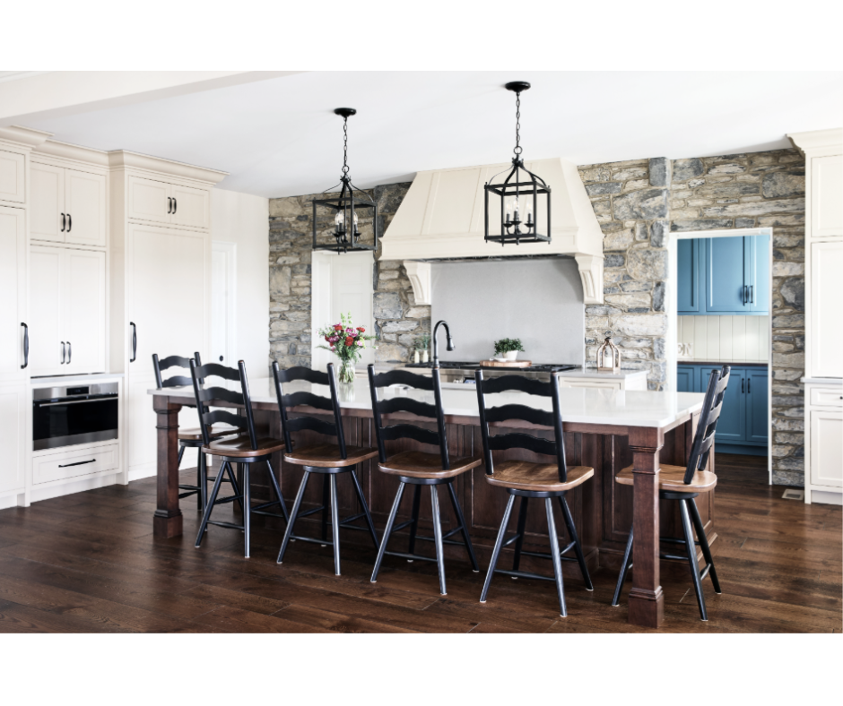 This Lebanon, PA kitchen remodel transforms a home with Kountry Kraft’s Penn Line custom cabinetry, finished in Benjamin Moore Hush AF-95. The kitchen blends classic design with modern functionality, featuring a large custom range hood over a Wolf double range, a vibrant blue butler’s pantry, and a spacious island seating six