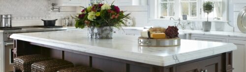 This is a picture of a kitchen with custom-made dark brown and white cabinetry by Kountry Kraft Custom Cabinetry