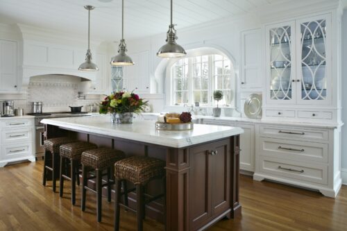 this is a picture of a white-themed kitchen with custom cabinet and storage by Kountry Kraft Custom Cabinetry.