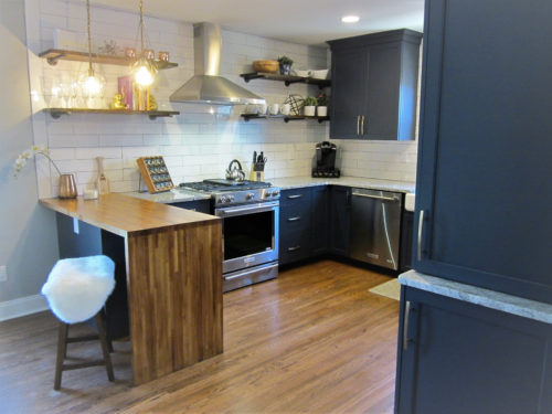 This Kitchen Features a G Shaped Kitchen Layout that Provides Extra Surface Space and Seating