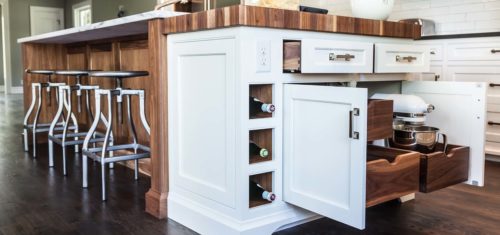 Stonington designed this custom cabinetry with walnut drawers and plenty of storage by Kountry Kraft