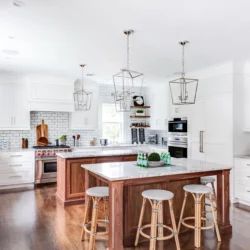 Two kitchen islands with natural marble Carrara countertops for a kitchen located in Madison, New Jersey