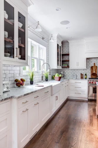 White transitional kitchen cabinets with marble Carrara countertops and subway tile in Madison, New Jersey