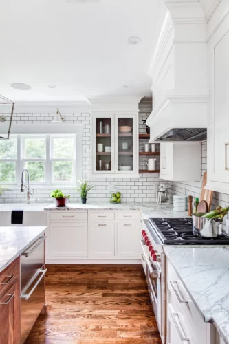 White transitional kitchen cabinets with marble Carrara countertops and subway tile in Madison, New Jersey