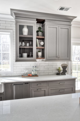 This Kitchen Features open Glass Shelving which is a Current Kitchen Cabinet Trend