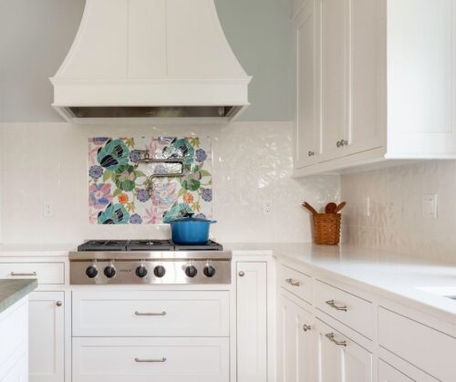 wolf cooktop with pot filler and a custom range hood