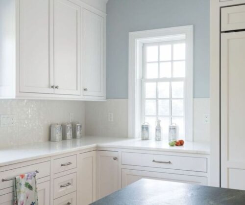 white kitchen with ample storage and a sunny window