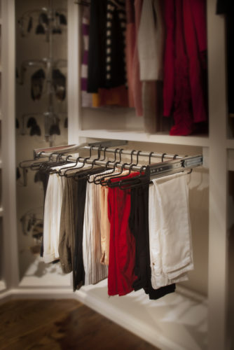 this custom closet features a pull out rack that creates easy accessibility