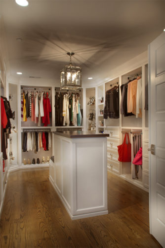 this custom closet includes custom features to create easy accessibility