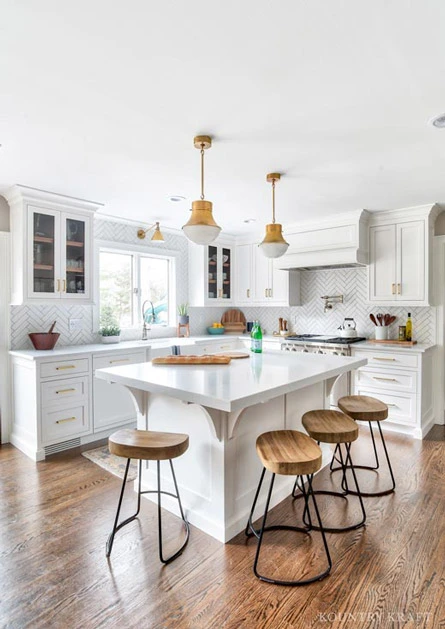 White U Shaped Kitchen Cabinets with Brass Hardware White Countertops Wood Floors in Montvale New Jersey