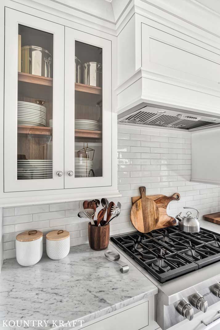 Alpine White Cabinetry with Glass Doors and Walnut Shelves for a Kitchen in Summit, NJ