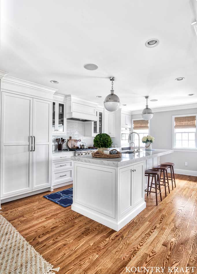 Alpine White Cabinetry in a transitional kitchen with wood flooring and silver fixtures in Summit, New Jersey