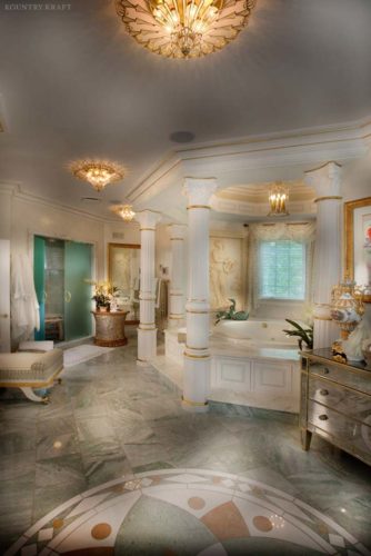 Elegant bathroom colored white and gold with pillars around the bathtub Chester Springs, PA